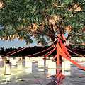 Charming Night Decoration With Large Tree Hanging Lanterns Red Ribbons And Ground Reflections