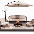Outdoor Wicker Sofa with Fire Pit Flames and Matching Chairs Under Umbrella
