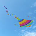 Colorful Rainbow Striped Kite With Long Tassel Tail On Light Blue Background