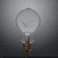 Transparent Glass Light Bulb With Filament And Golden Base On Gray Background