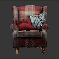 Plaid Upholstered Armchair With Red And Blue Pillows And Wooden Legs