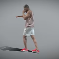 Man in Striped Tank Top White Shorts Red Sneakers Practicing Boxing Stance on Gray Background