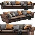 Modern Brown Leather Two-Seater Sofa With Plush Pillows And Cozy Blanket