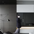 Woman in dark coat with blurry back near black floor lamp and grey striped wall