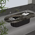 Modern Oval Coffee Table With Marble Top Black Base And Coffee Cup Book Glass