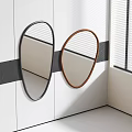Two Oval Mirrors With Black And Brown Frames On White Wall With Black Accent Stripes