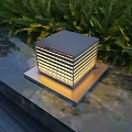 Square Illuminated Outdoor Light On Stone Slab Surface With Green Foliage
