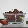 Fresh Ripe Strawberries in Glass Bowl with Sliced Strawberry and Green Leaf on White Background