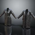 Two Silver Quilted Coats Display With Open Sleeves And Shiny Fabric Texture
