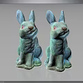 Two Turquoise Decorative Sitting Rabbit Statues on Dark Reflective Surface