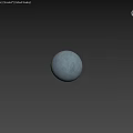 Gray Spherical Component Placed On Wooden Surface Against Textured Wall