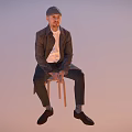 Man sitting on chair wearing hat jacket white shirt dark pants shoes against light background