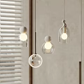 Set of Modern Glass Pendant Lights With Round Shades Hanging Near Window Blinds
