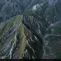 Aerial View Of Mountainous Landscape With Lush Green Forest And Winding River