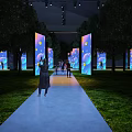 Outdoor Pathway With Illuminated Screens Colorful Patterns Trees And People Taking