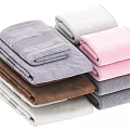 Neatly Stacked Assorted Color Towels With Gray White Pink Brown Tones