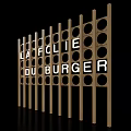 Wooden Decorative Screen With Circular Holes Displaying LA FOLIE DU BURGER