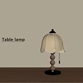Table lamp with wooden base metal accents and light colored petal lampshade on wooden table