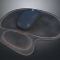Black Computer Mouse Resting On Brown Ergonomic Mouse Pad Surface
