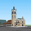 European Style Commercial Complex With Green Roof Clock Tower And Timber Frame Storefronts