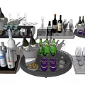 Assorted Wine Bottles And Glasses Arranged On Trays With Ice Buckets And Accessories