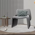 Gray Leisure Chair With Green Cushion On Round Rug By Side Table And Floor Lamp