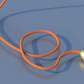 Coiled Orange Rope With Gold Ball End For Daily Household Use On Blue Background