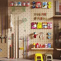 Sports Equipment Organized On Pegboard Wall With Shelves Holding Fishing Rods And Gear