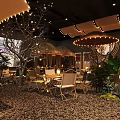 Cozy Tropical Bar Interior With String Lights Green Plants Wooden Tables And Pebble Floor