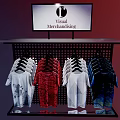Retail Display Shelf with Digital Screen Showing Visual Merchandising and Hanging Colorful Printed T-shirts
