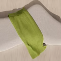 Abstract Shape Gray Fabric Sofa With Green Throw Blanket On Wooden Floor