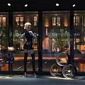 Elegant Window Display With Mannequins Fashion Bags And Decorative Lighting Elements