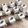 Elegant Banquet Table Setup With White Tablecloths And Purple Flower Bouquets