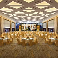 Elegant Spacious Banquet Hall With Round Tables Geometric Ceiling And Stage Setup