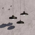 Three Modern Black Pendant Lights Hanging Over Textured Marble Wall 3d model