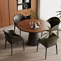 Modern Dining Area With Round Table Black Chairs Green Plant And Area Rug