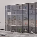 Various Action Figures Displayed in Glass Door Cabinet with Multiple Shelves and Indoor Potted Plant