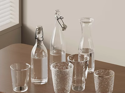 Clear Glass Bottles And Drinking Glasses Display On Wooden Table 3d model