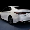 White Toyota Camry Sedan on Blue Display Stand with Black Background