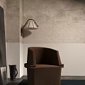 Comfortable Brown Fabric Accent Chair in Modern Room with Gray White Walls and Wall Lamp