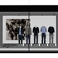 Fashion Store Window Display With Mannequins In Colored Tops And Black White Artwork