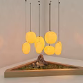 Round Yellow Pendant Lights Above Wooden Triangular Tray With Moss And Stone In Soft Light