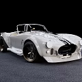 White Convertible Sports Car With Black Racing Stripes And Large Alloy Wheels