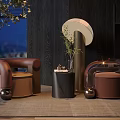 Modern Brown Single Sofa With Round Metal Base Small Table And Green Plant