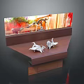 Two Origami Cranes Perched on Wooden Shelf by Window with Outdoor Plants Background