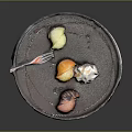 Delicious Assorted Food On Black Plate With Lemon Slices Cream Orange And Sauce