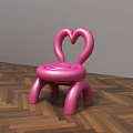 Pink Kids Chair With Heart Shaped Backrest And Rounded Design On Wooden Floor