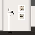 Framed Abstract Paintings Hanging On Wall In Modern Interior With Black Floor Lamp