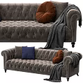 Elegant Dark Gray Tufted Sofa with Brown Blue Pillows and Gray Blanket