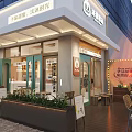 Elegant Modern Dessert Shop With Outdoor Seating Green Plants And Signboard